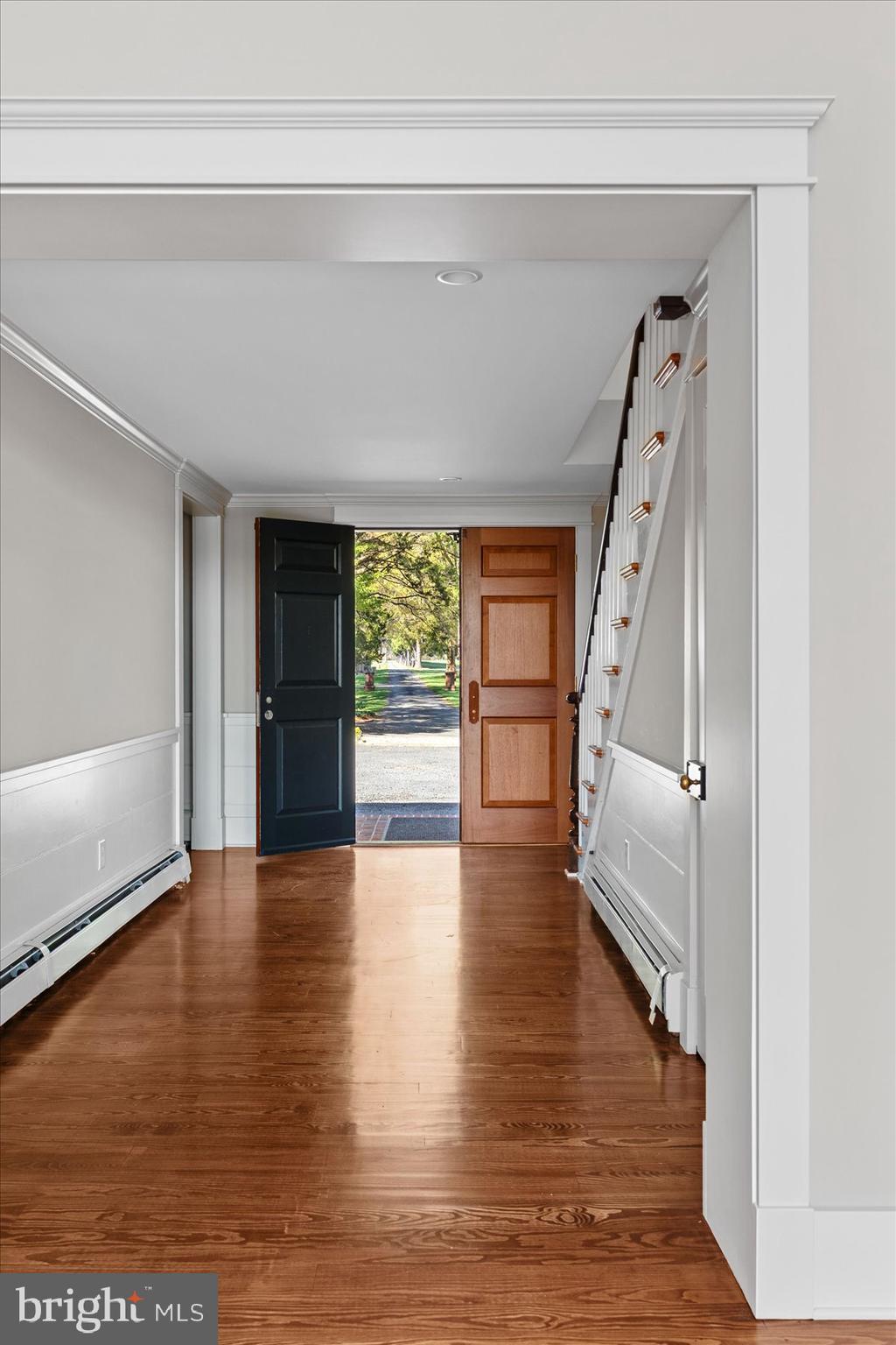 29031 Howell Point Road Trappe, MD 21673 - Photo 27 of 129 a view of an empty room with wooden floor and a window