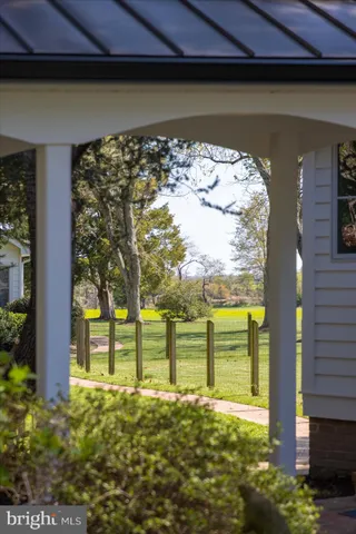 a view of a green field with an ocean view