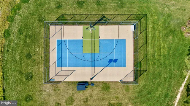 an aerial view of a house with a yard and trees