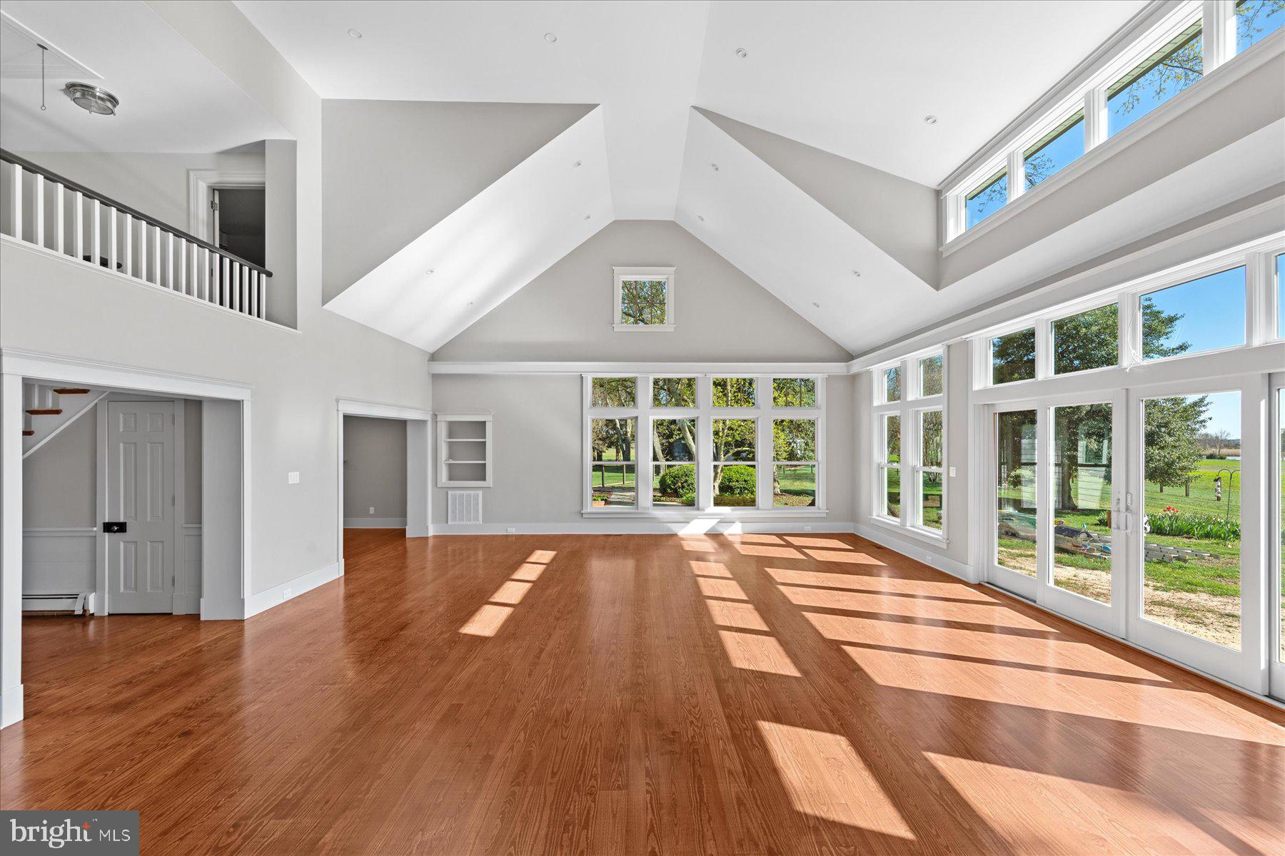 29031 Howell Point Road Trappe, MD 21673 - Photo 44 of 129 a view of an empty room with wooden floor and a window