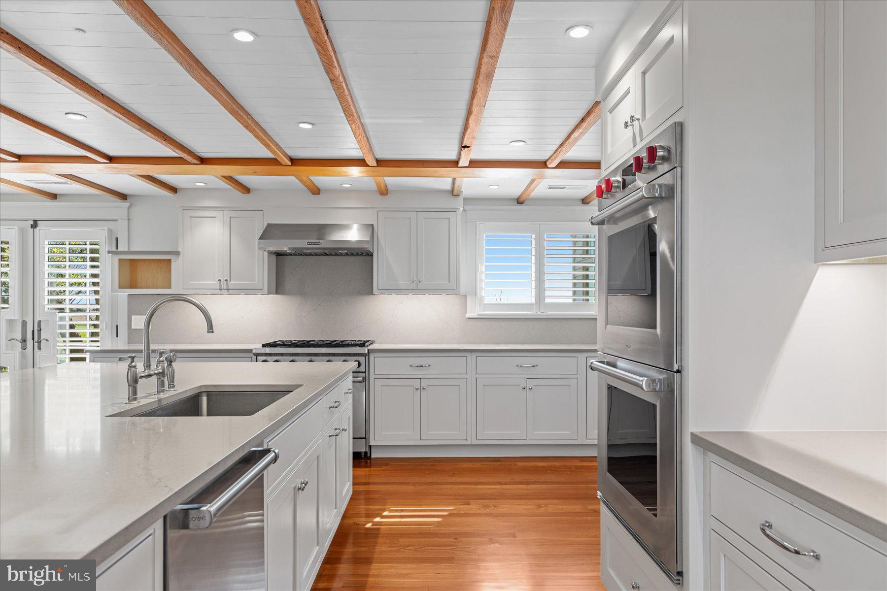 29031 Howell Point Road Trappe, MD 21673 - Photo 49 of 129 a kitchen with stainless steel appliances granite countertop a sink a stove and a refrigerator