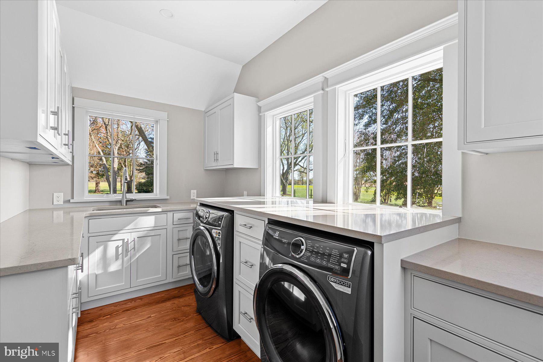 29031 Howell Point Road Trappe, MD 21673 - Photo 55 of 129 a utility room with cabinets dryer and washer