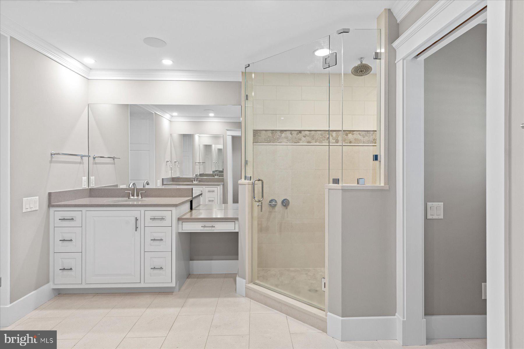 29031 Howell Point Road Trappe, MD 21673 - Photo 56 of 129 a bathroom with a granite countertop sink mirror and shower