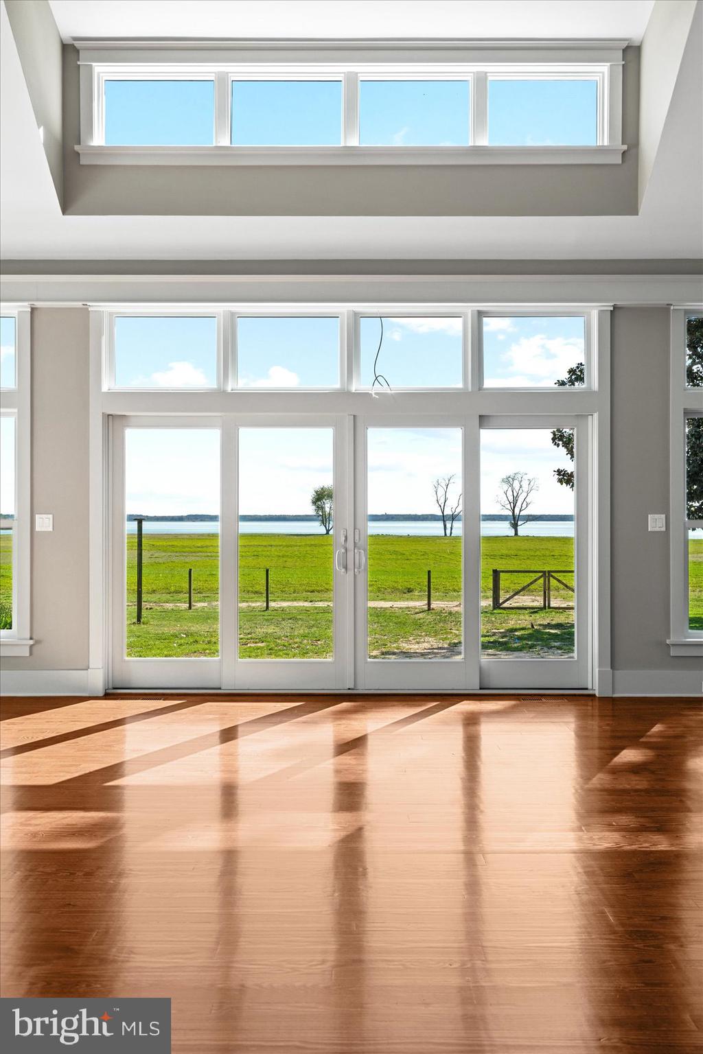 29031 Howell Point Road Trappe, MD 21673 - Photo 67 of 129 a view of an empty room with wooden floor and a window