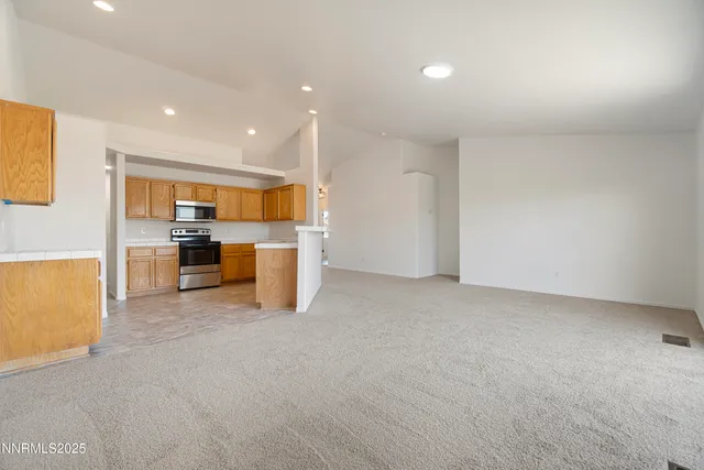 a kitchen with stainless steel appliances granite countertop a sink stove and microwave