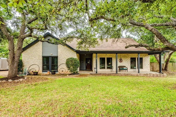a front view of a house with swimming pool and porch with furniture