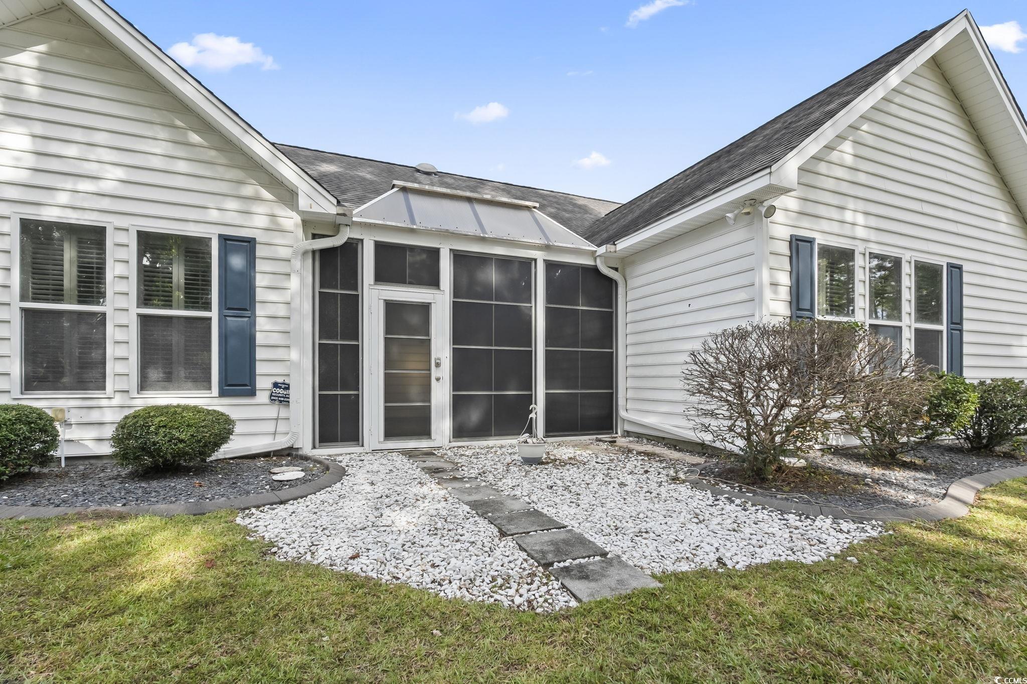 743 Helms Way Conway, SC 29526 - Photo 13 of 37 Rear view of house featuring a sunroom, a shingled roof, and a lawn