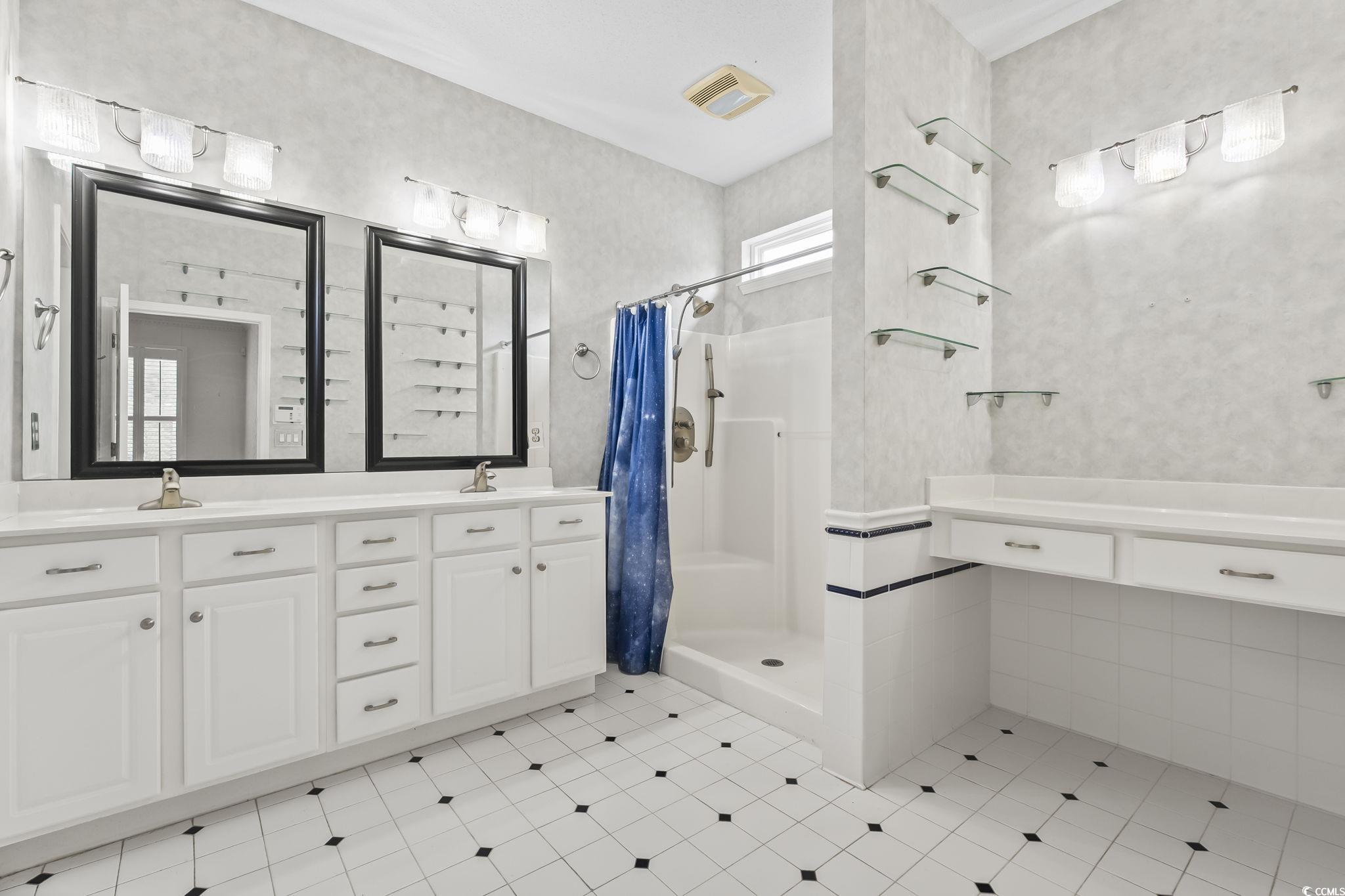 743 Helms Way Conway, SC 29526 - Photo 25 of 37 Full bathroom with double vanity, a stall shower, and light tile patterned flooring