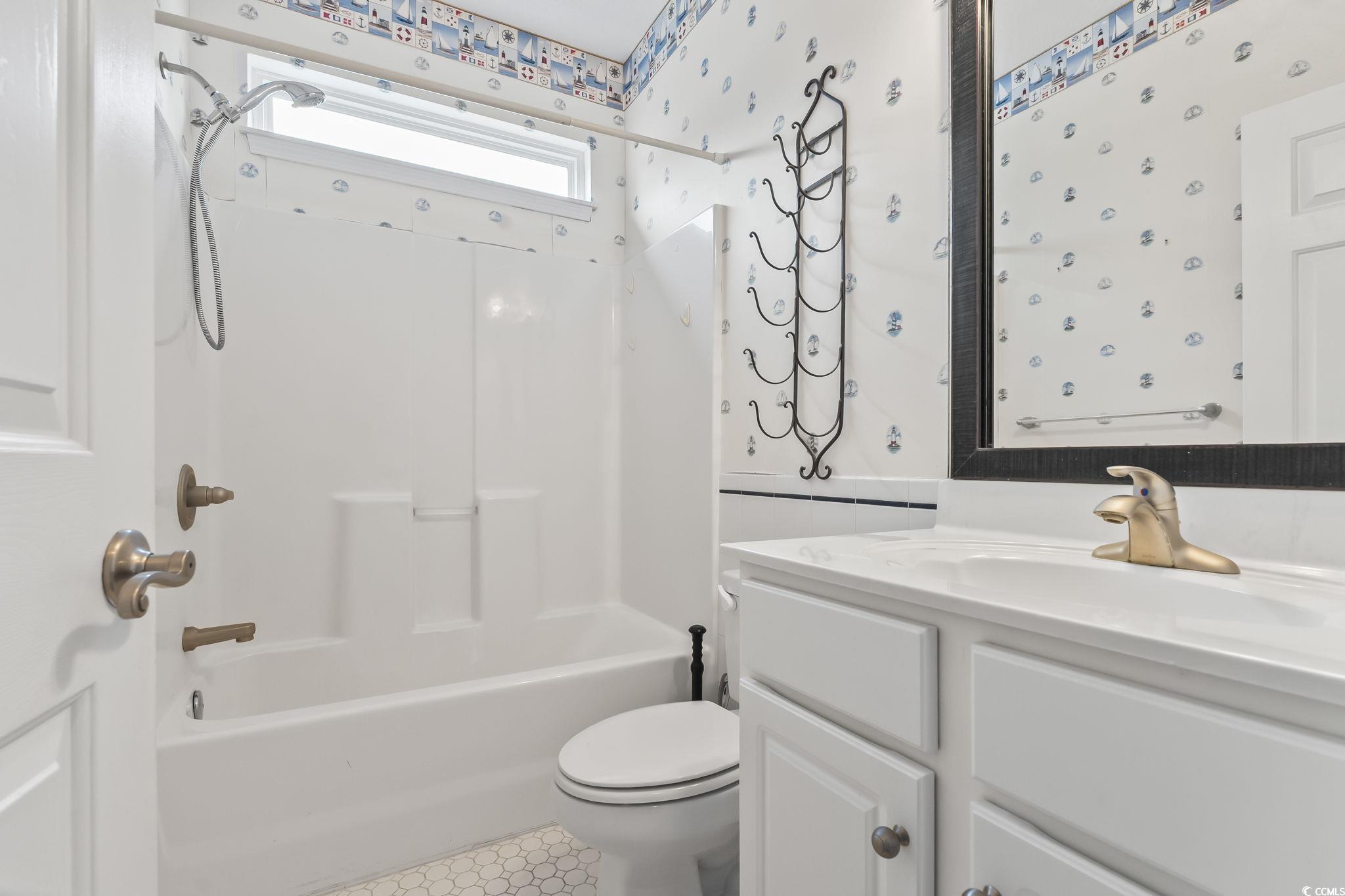 743 Helms Way Conway, SC 29526 - Photo 31 of 37 Full bath with tub / shower combination, vanity, wallpapered walls, and tile patterned flooring