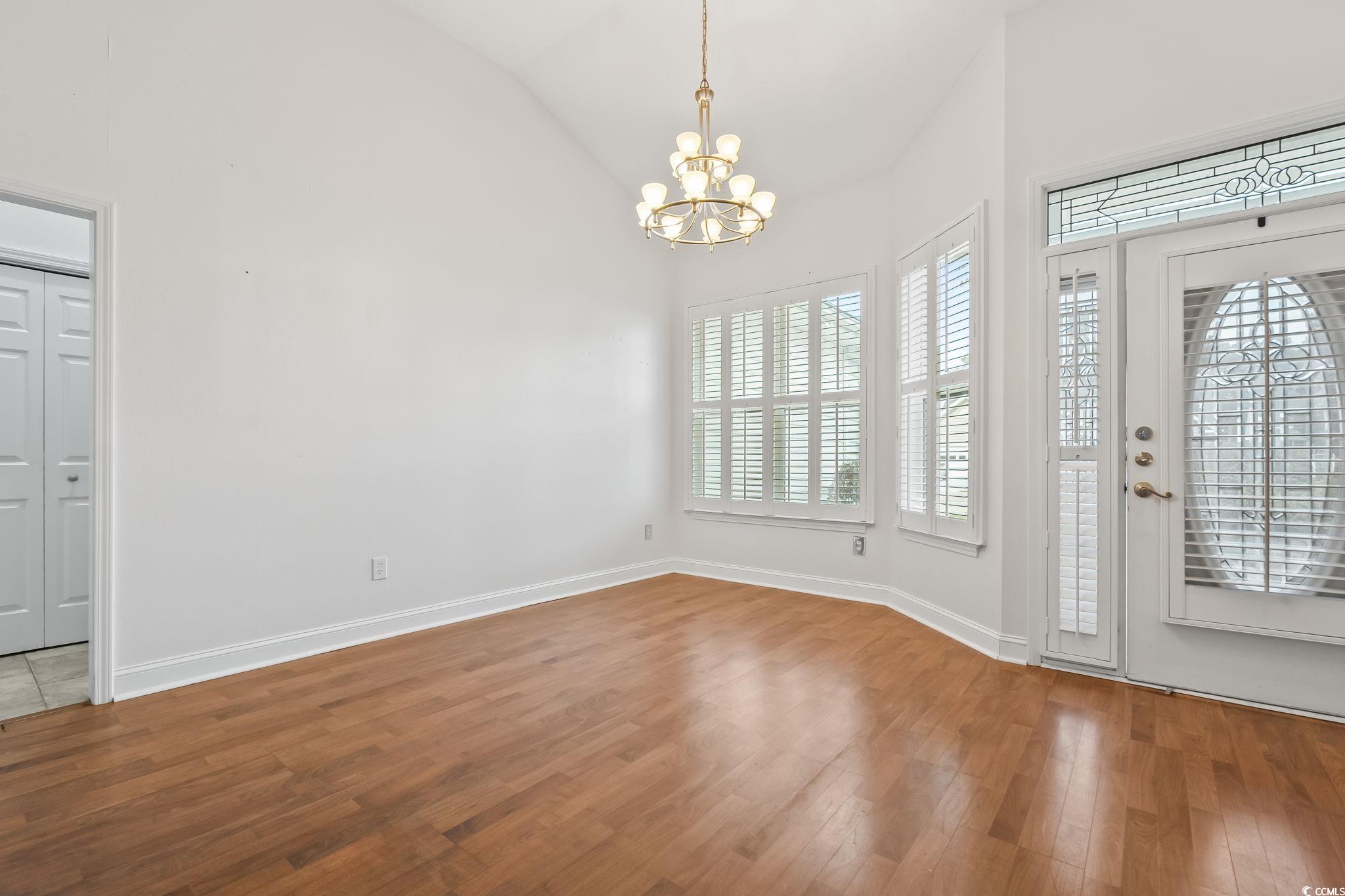 743 Helms Way Conway, SC 29526 - Photo 8 of 37 Unfurnished dining area featuring light wood finished floors, a chandelier, and high vaulted ceiling