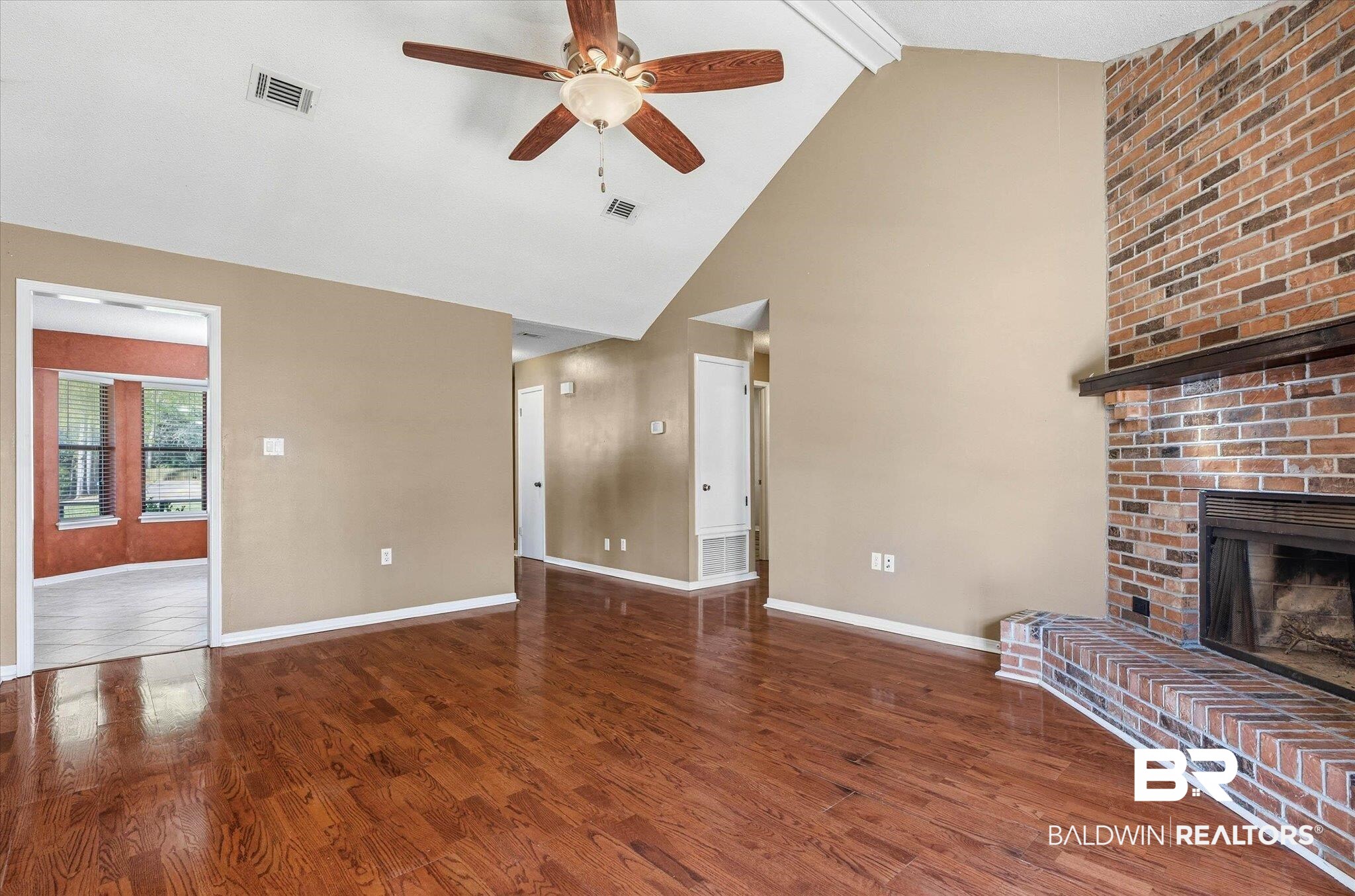 8030 Country Drive Mobile, AL 36619 - Photo 4 of 22 Unfurnished living room featuring a fireplace, dark wood finished floors, and a ceiling fan