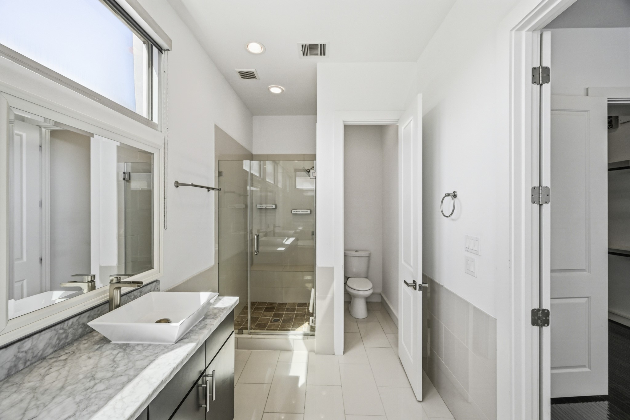 5228 Maxie Street, Unit A Houston, TX 77007 - Photo 18 of 28 The primary bathroom has large windows, recessed lighting, garden tub and separate walk-in shower.