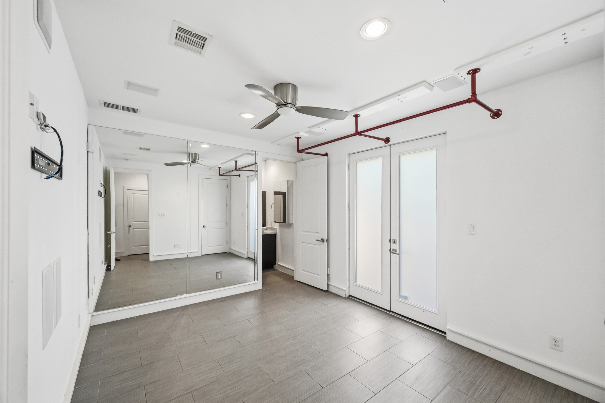 5228 Maxie Street, Unit A Houston, TX 77007 - Photo 8 of 28 Secondary bedroom on first floor with neutral tones, access to the patio, and natural light.