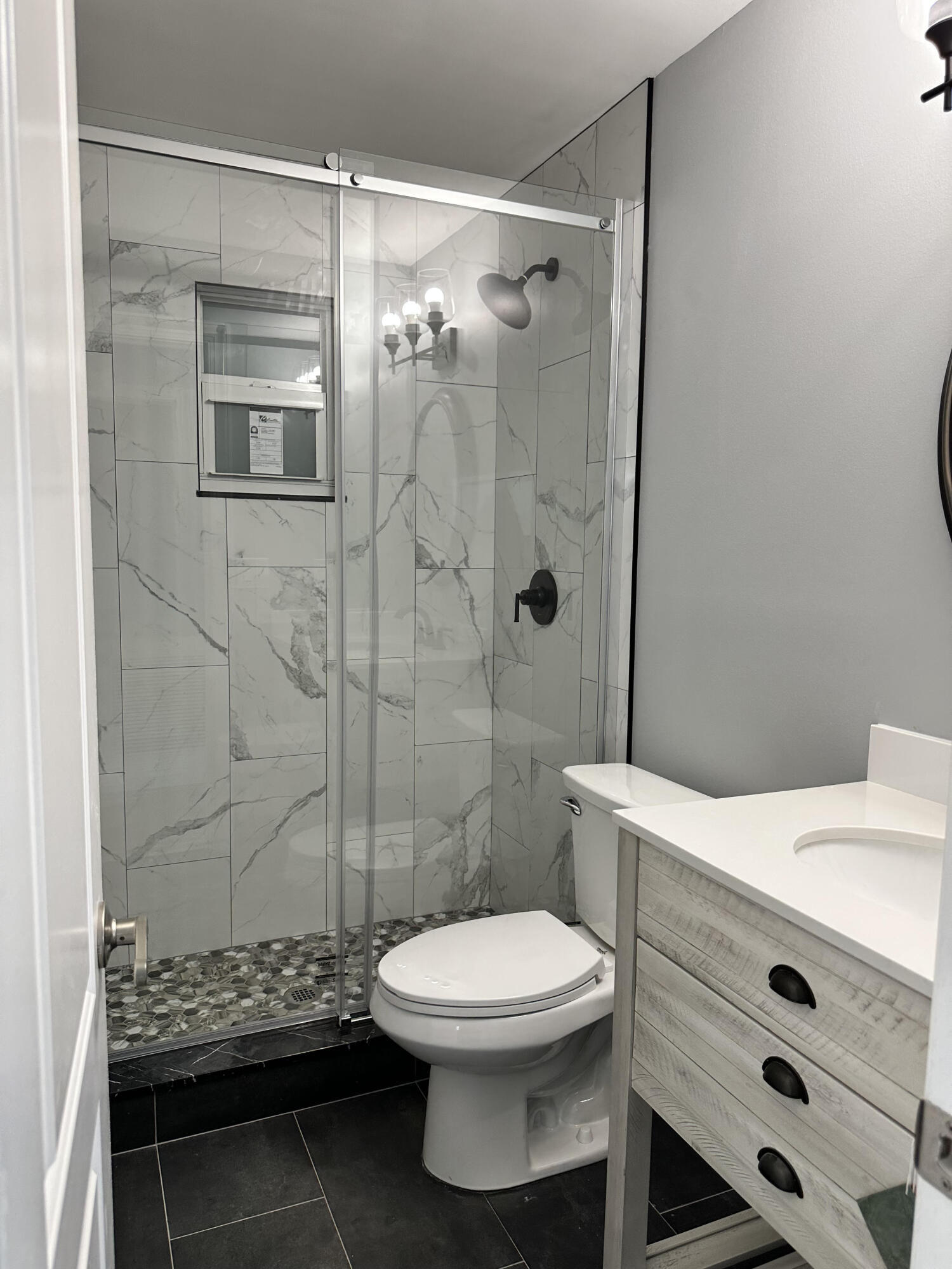2814 Southeast Indian Street Stuart, FL 34997 - Photo 14 of 23 a bathroom with a toilet a sink and shower