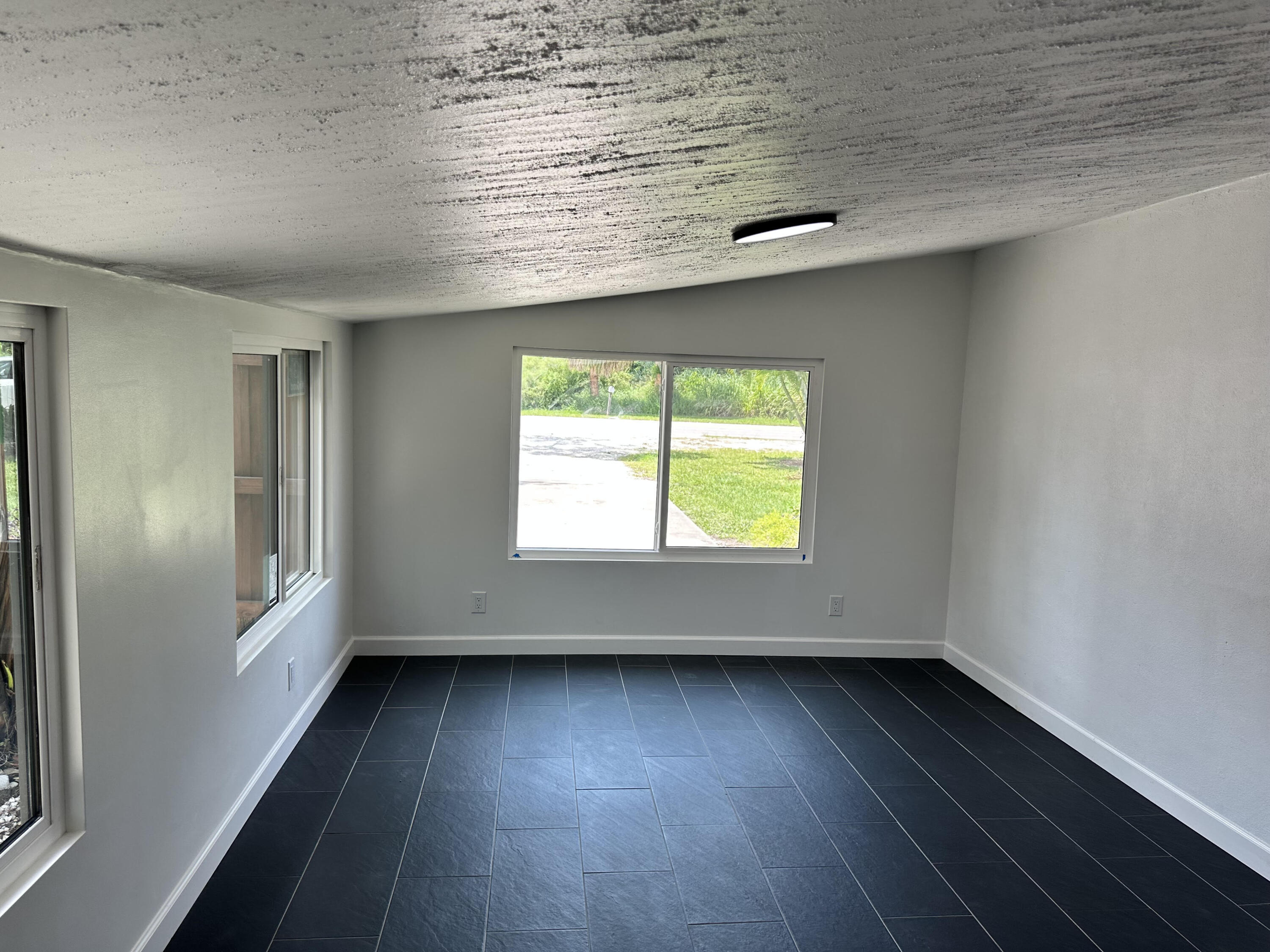 2814 Southeast Indian Street Stuart, FL 34997 - Photo 17 of 23 an empty room with wooden floor and windows