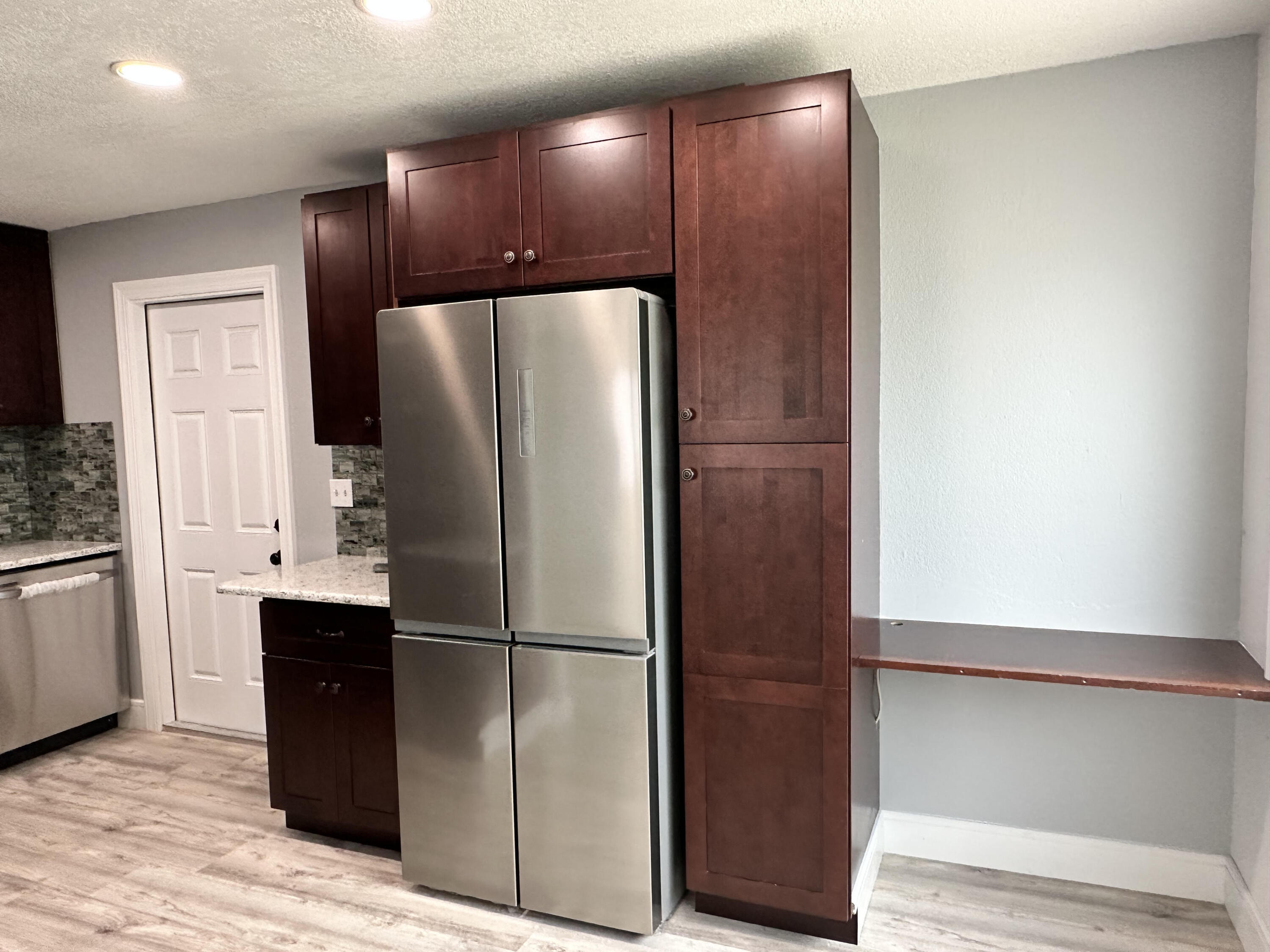 2814 Southeast Indian Street Stuart, FL 34997 - Photo 2 of 23 a metallic refrigerator freezer sitting in a kitchen