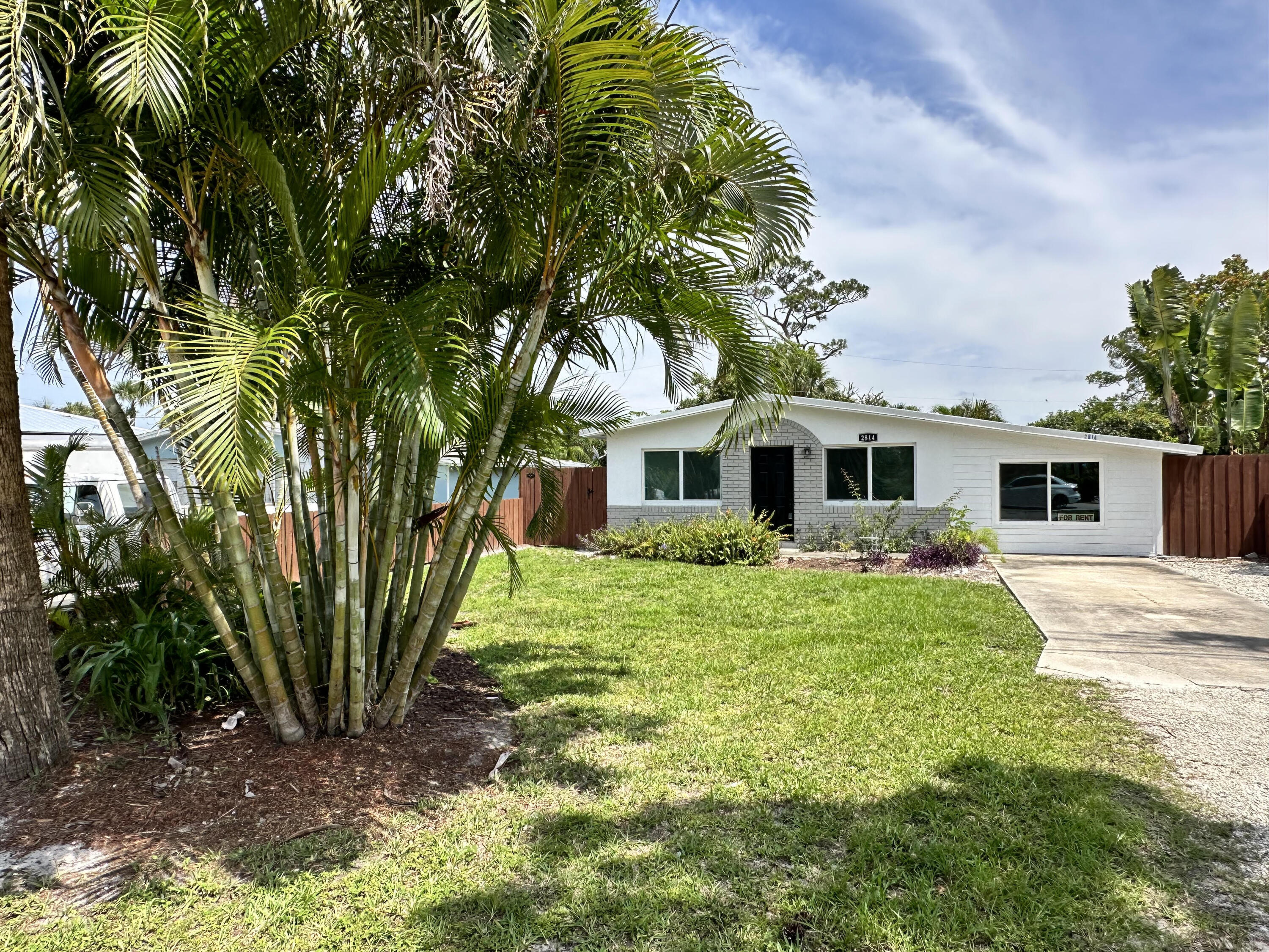 2814 Southeast Indian Street Stuart, FL 34997 - Photo 21 of 23 a front view of a house with a yard