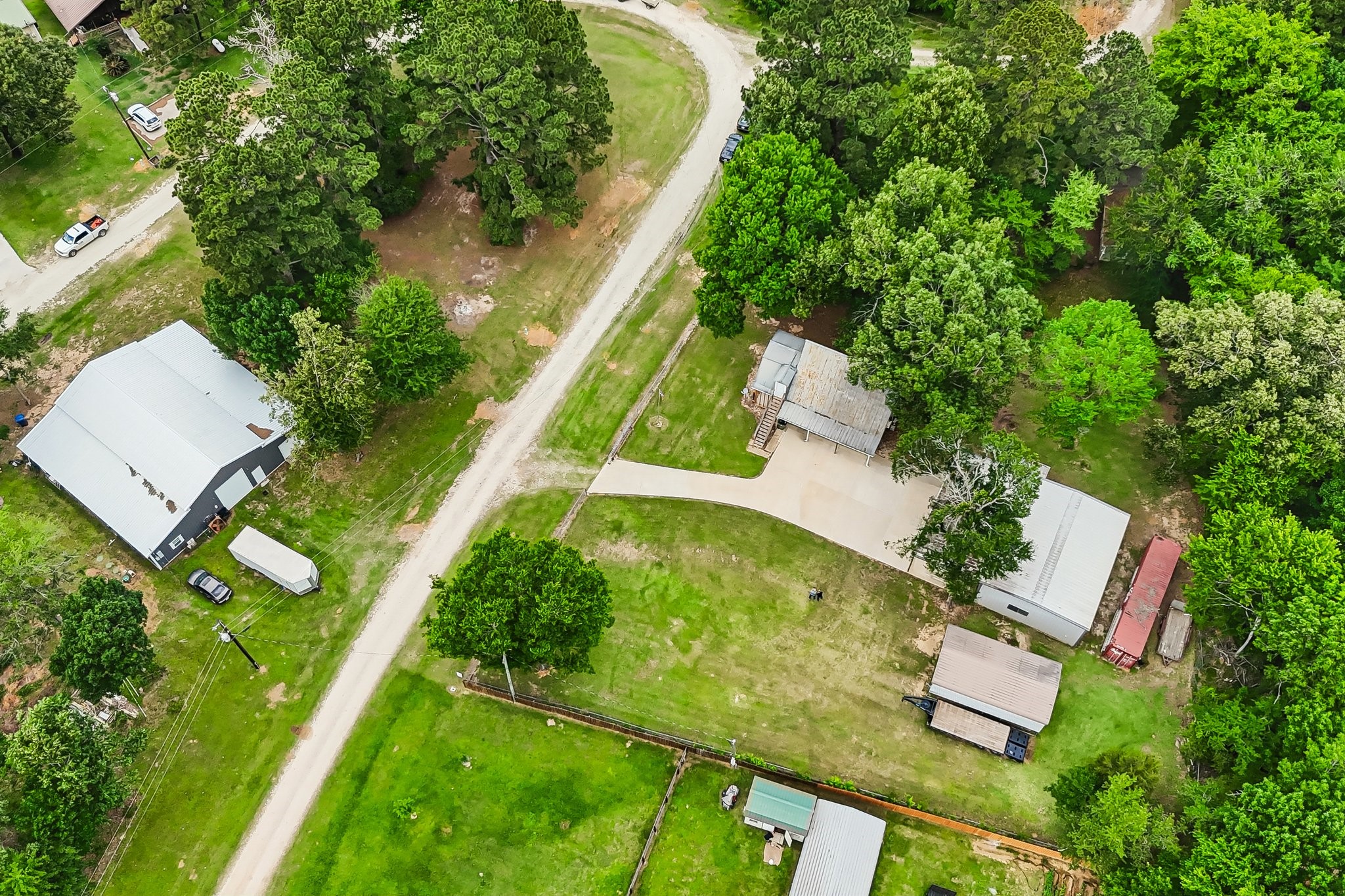 164 Frank Road Trinity, TX 75862 - Photo 11 of 20 Curb appeal meets security with this gated entrance. A long, pristine concrete driveway leads you into the heart of the property, offering a warm welcome and a sense of total privacy.