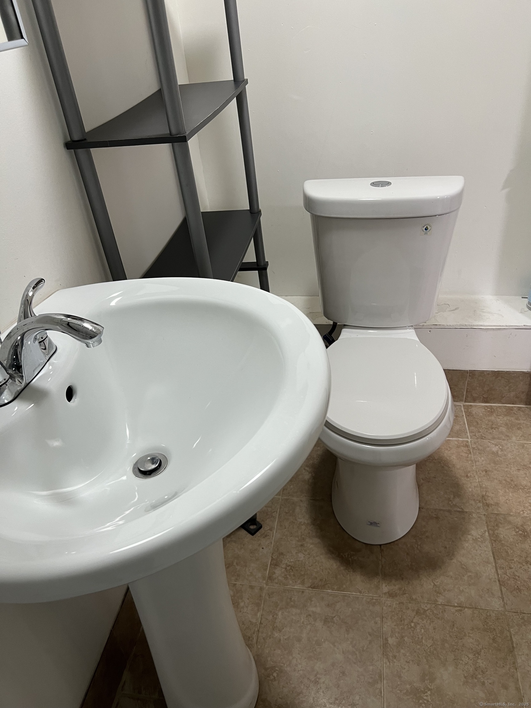 302 Dover Street Bridgeport, CT 06610 - Photo 14 of 15 a white toilet sitting next to a white sink