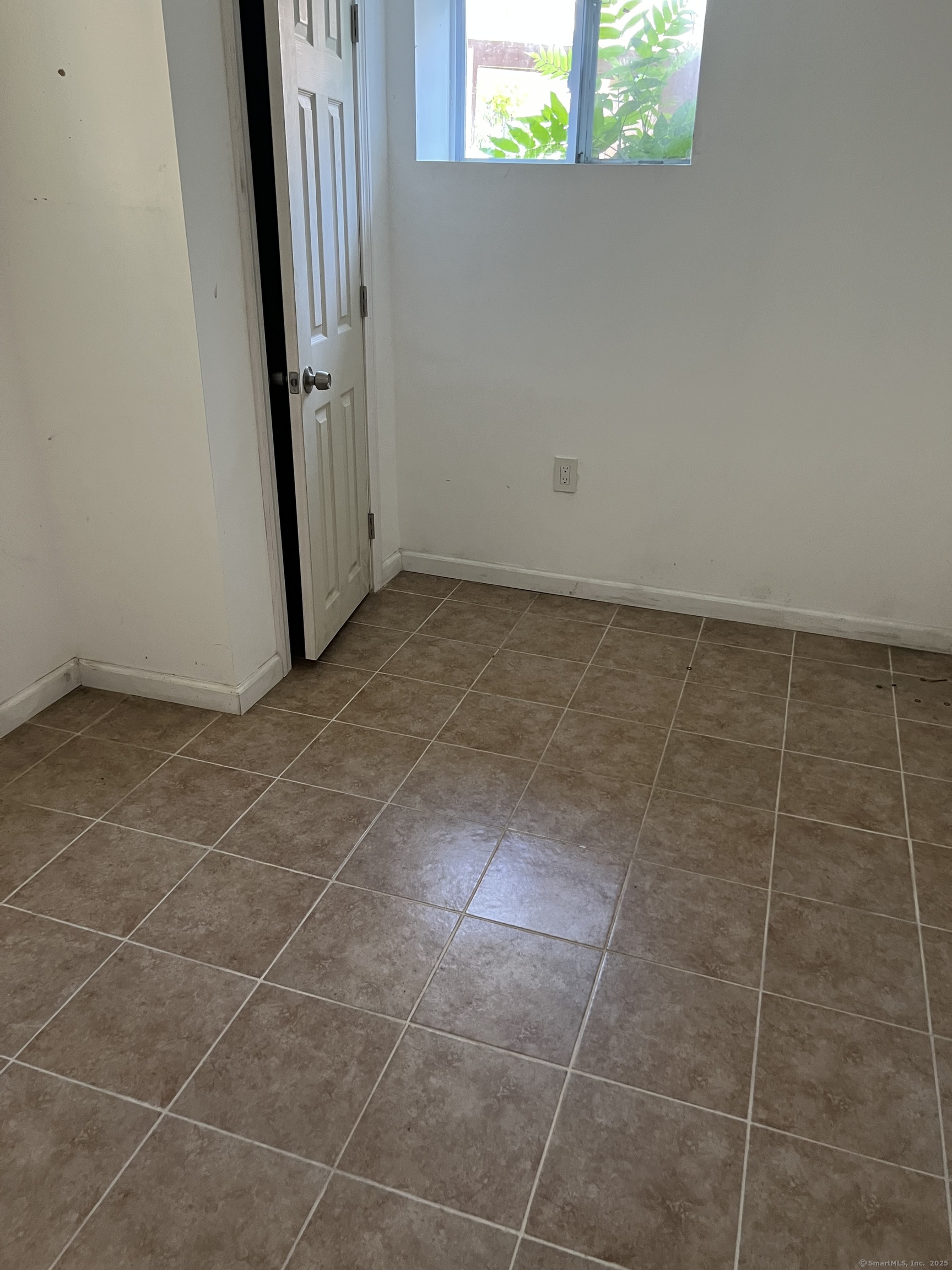 302 Dover Street Bridgeport, CT 06610 - Photo 15 of 15 a view of a small space with wooden floor and a window