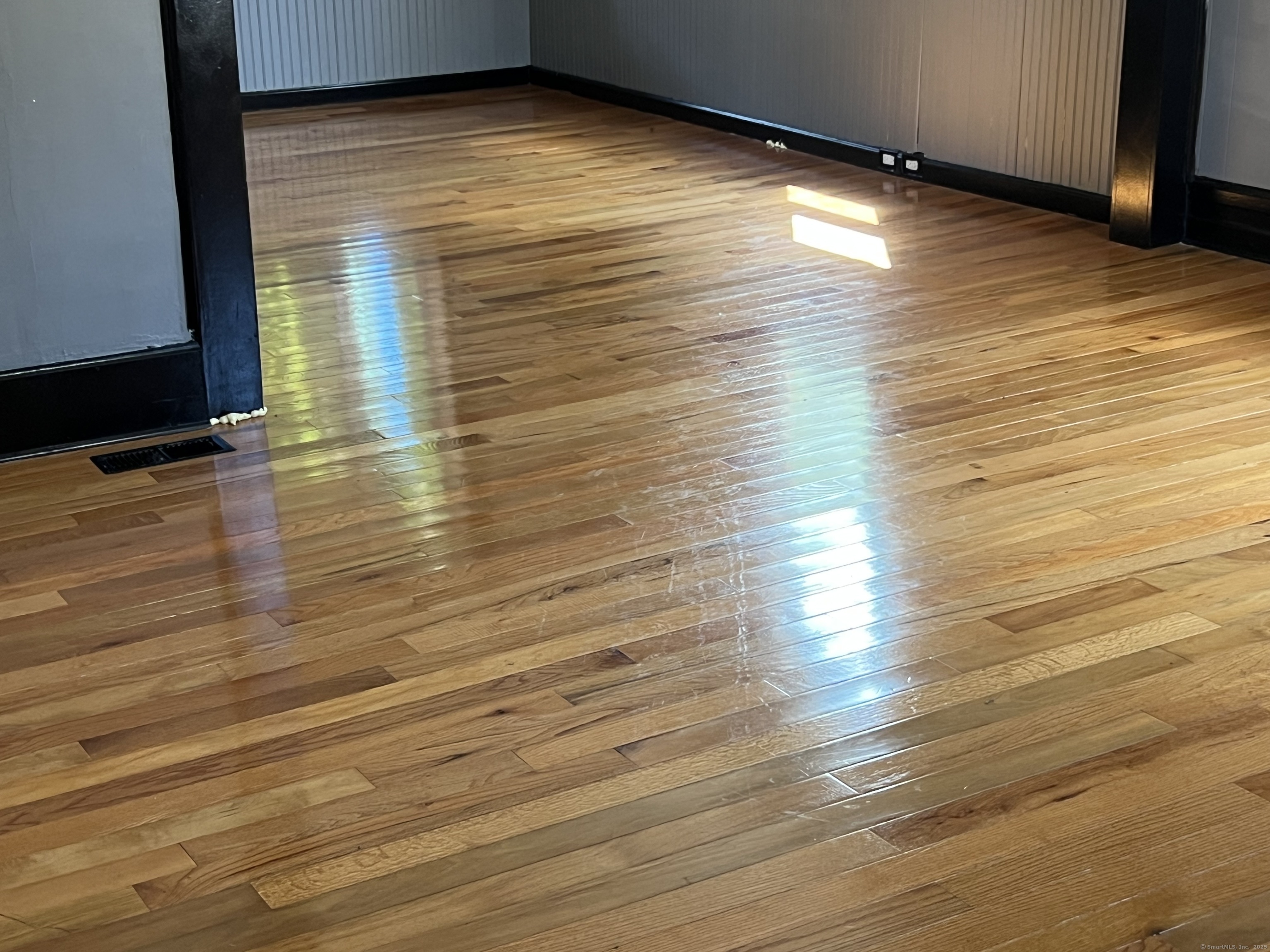 302 Dover Street Bridgeport, CT 06610 - Photo 2 of 15 a view of empty room with wooden floor