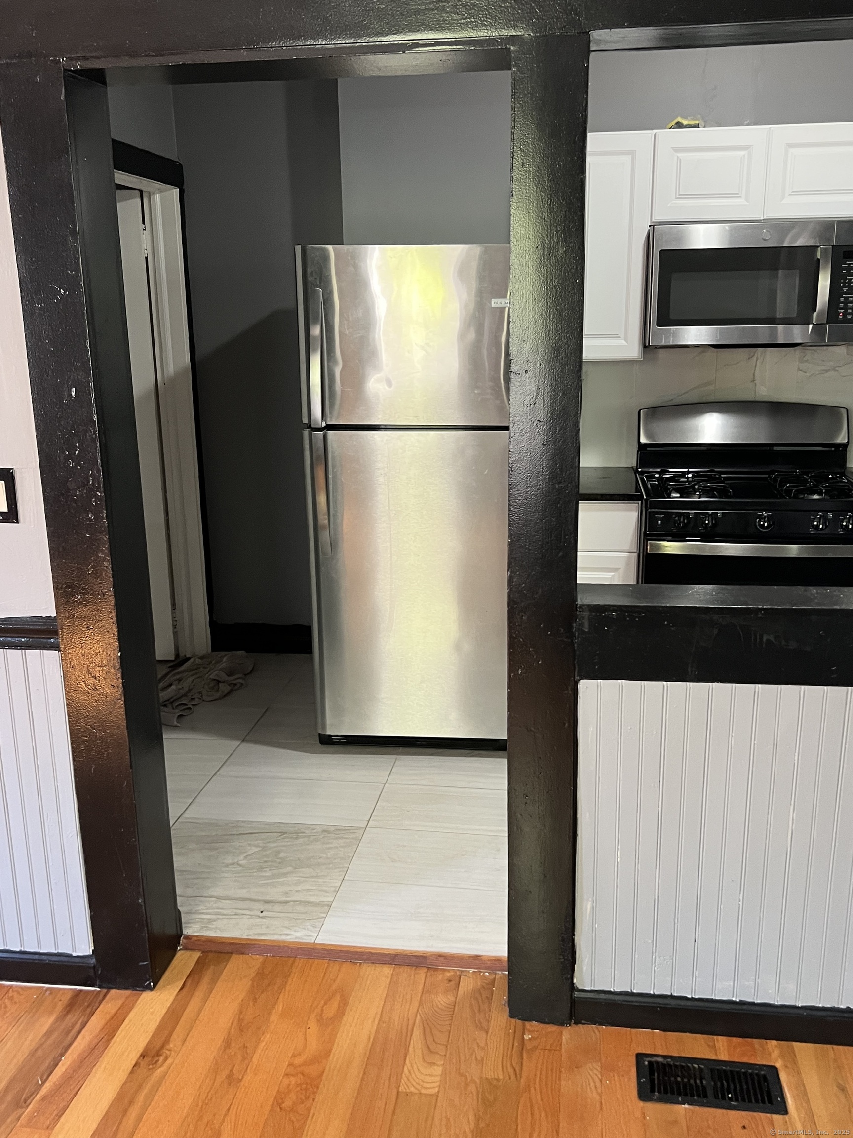 302 Dover Street Bridgeport, CT 06610 - Photo 3 of 15 a kitchen with a refrigerator and a stove