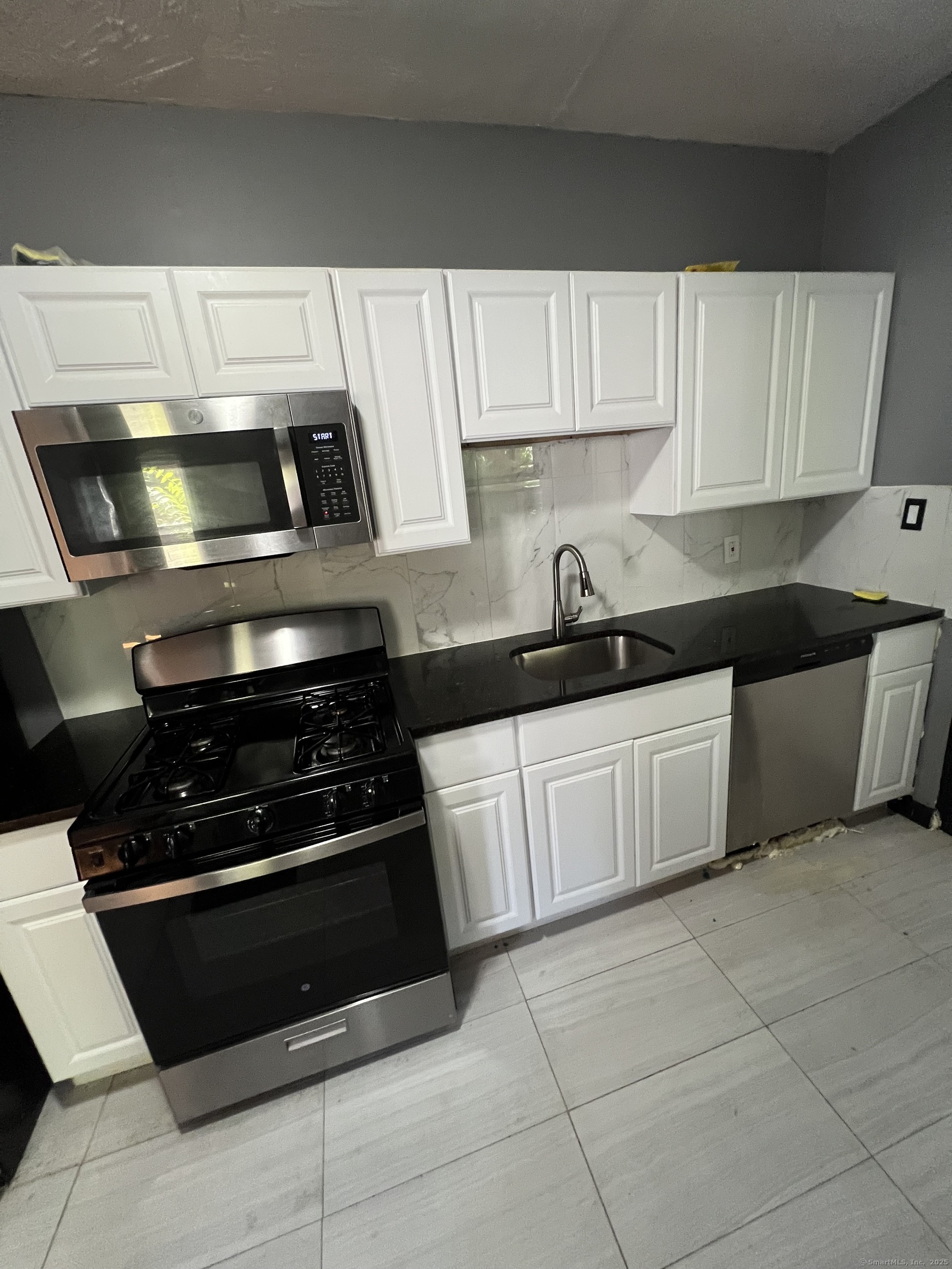 302 Dover Street Bridgeport, CT 06610 - Photo 4 of 15 a kitchen with cabinets and appliances