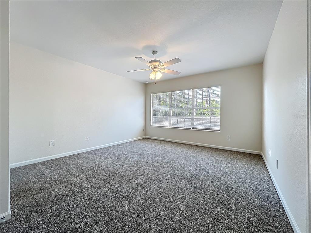12930 Vennetta Way Windermere, FL 34786 - Photo 17 of 38 an empty room with windows and fan