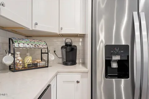 a kitchen with a refrigerator and cabinets