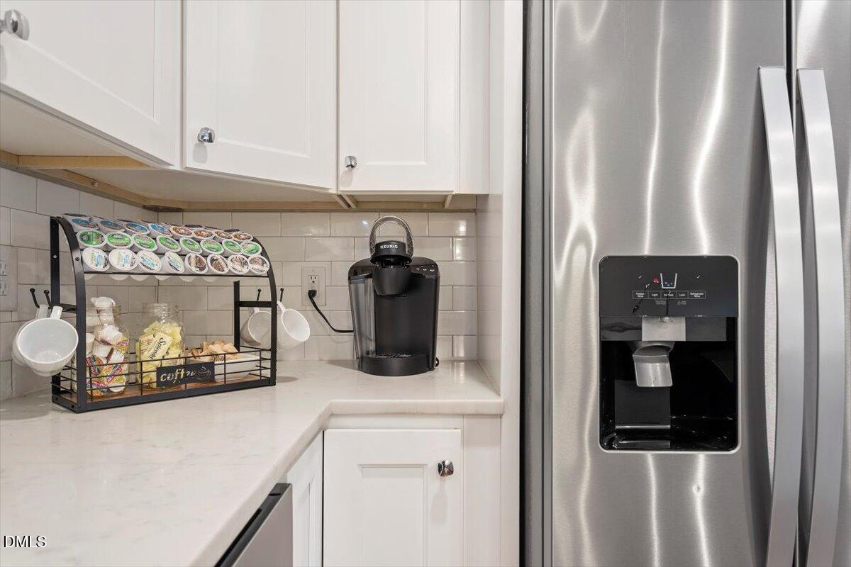 2120 Hillock Drive Raleigh, NC 27612 - Photo 17 of 29 a kitchen with a refrigerator and cabinets