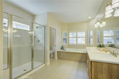 a spacious bathroom with a bathtub shower and sink