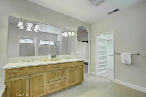 a bathroom with a double vanity sink and a mirror