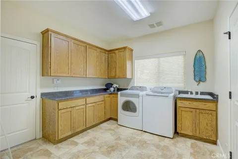 a utility room with sink dryer and washer
