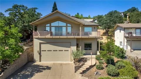 an aerial view of a house with a yard and sitting area