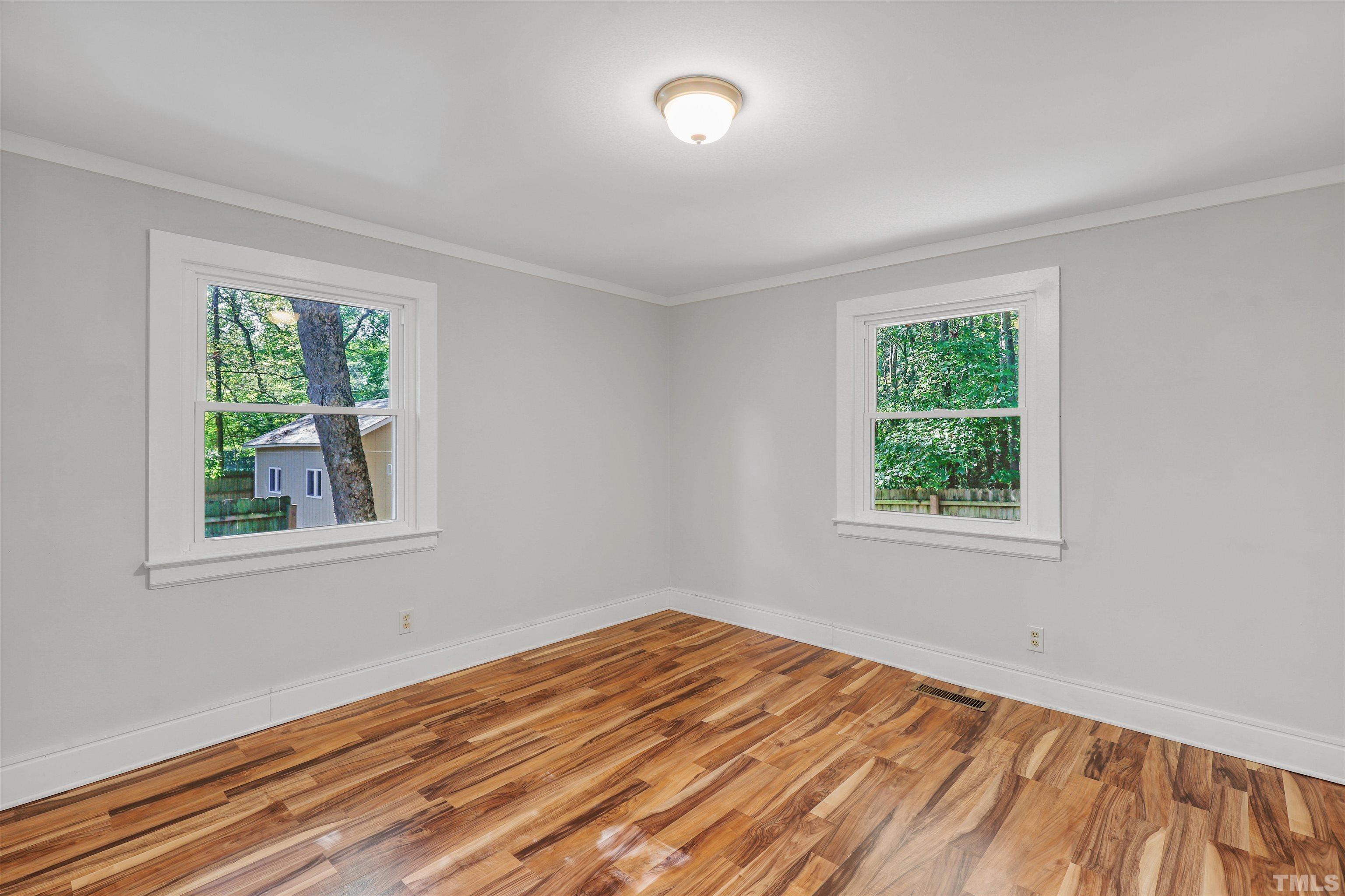 2706 Dearborn Drive Durham, NC 27704 - Photo 12 of 24 an empty room with wooden floor and windows