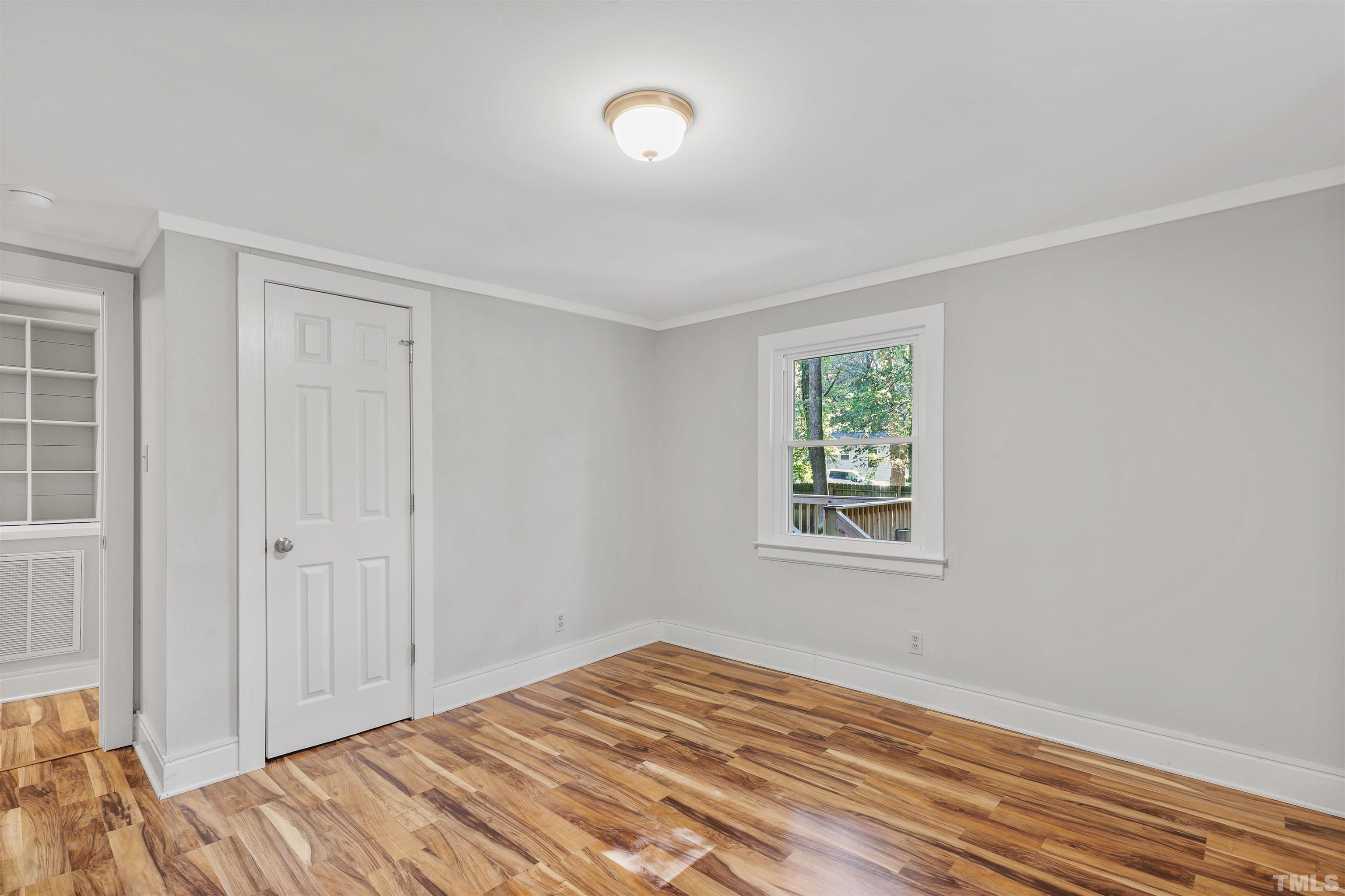 2706 Dearborn Drive Durham, NC 27704 - Photo 13 of 24 a view of a bedroom with a window and wooden floor