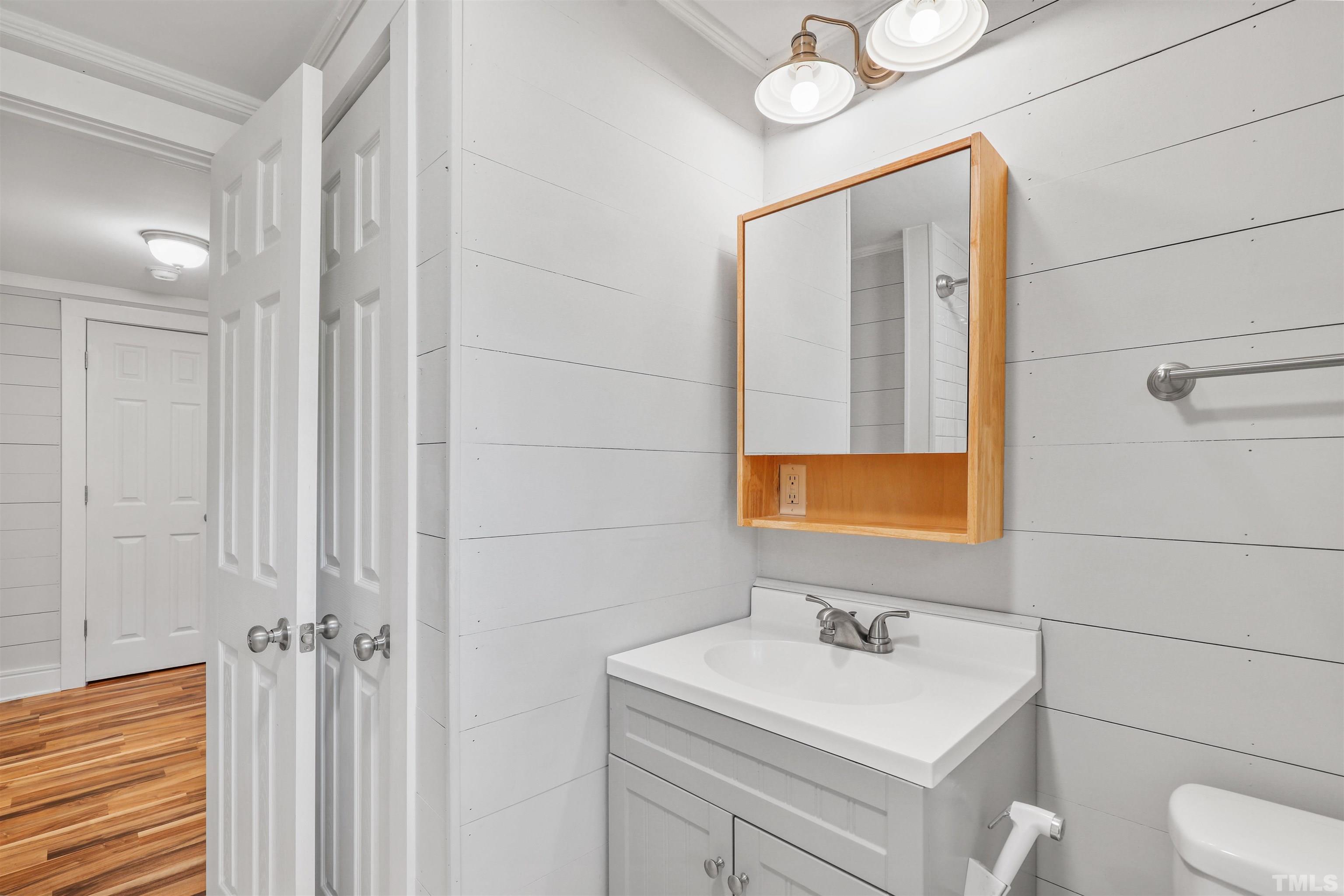 2706 Dearborn Drive Durham, NC 27704 - Photo 14 of 24 a bathroom with a sink a toilet and mirror