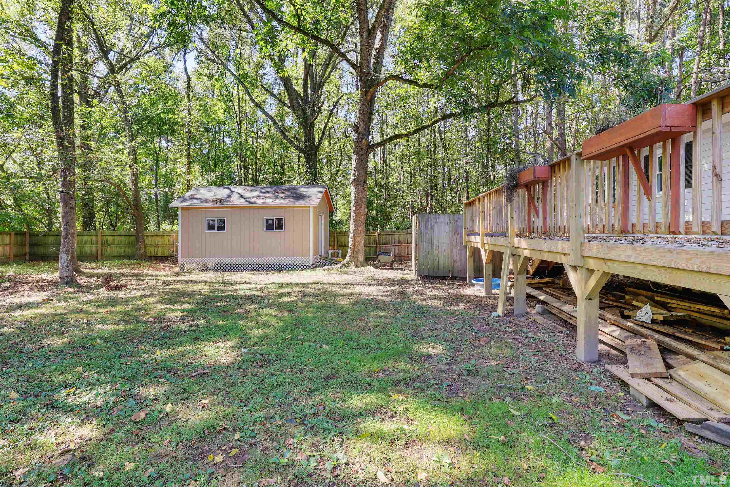 2706 Dearborn Drive Durham, NC 27704 - Photo 21 of 24 a backyard of a house with barbeque oven a table and chairs