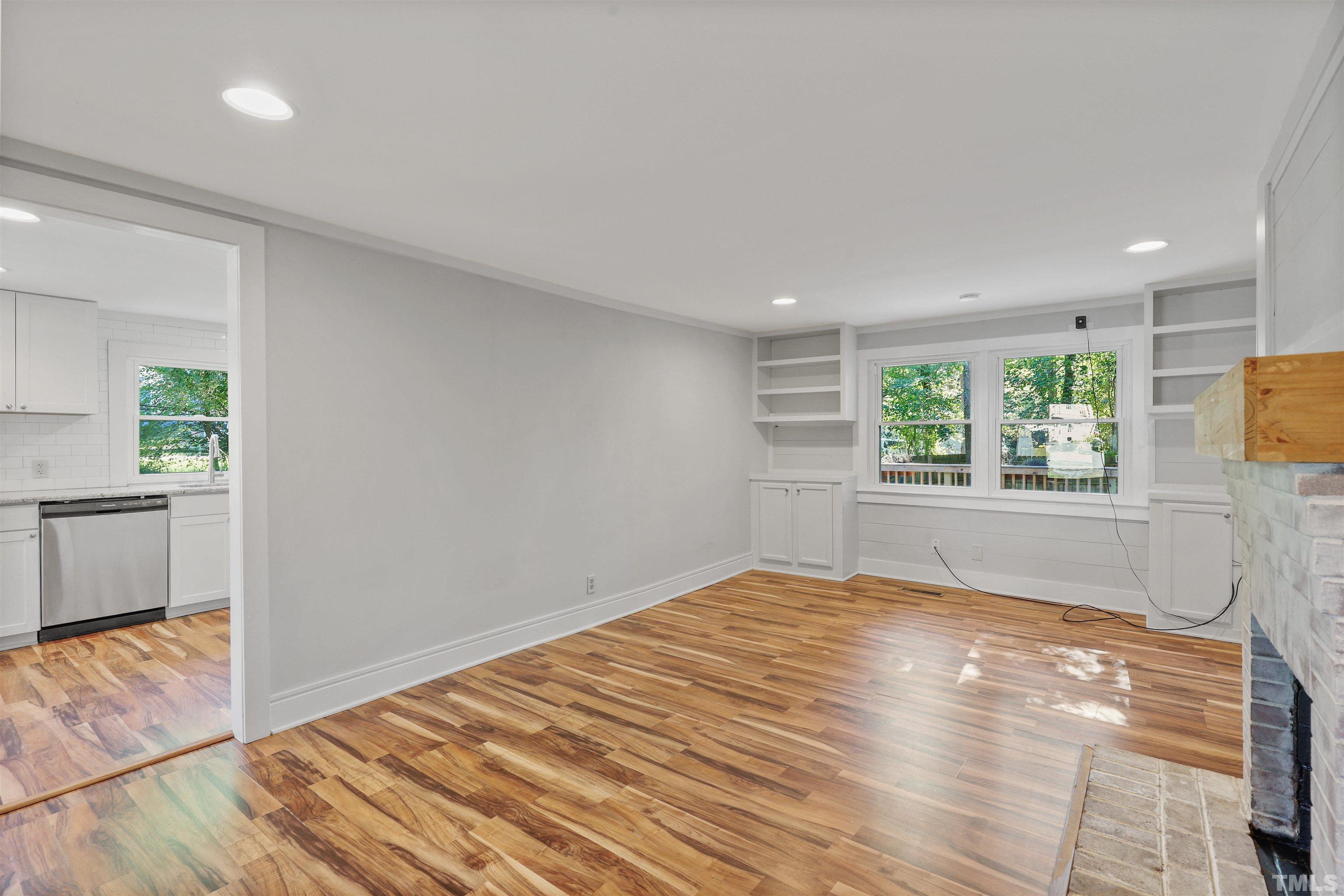 2706 Dearborn Drive Durham, NC 27704 - Photo 4 of 24 a view of empty room with wooden floor and fan