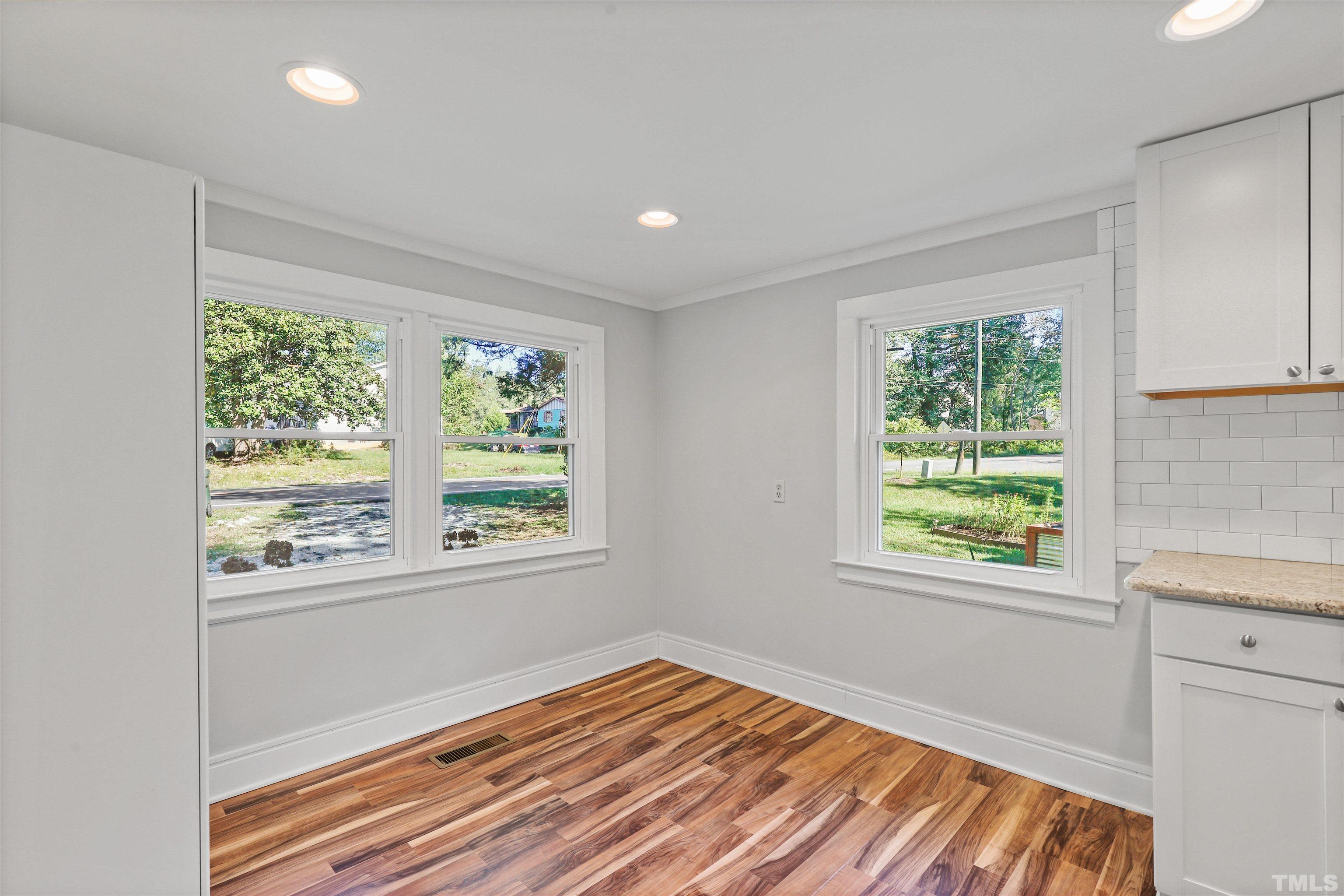 2706 Dearborn Drive Durham, NC 27704 - Photo 8 of 24 a view of an empty room with wooden floor and a window