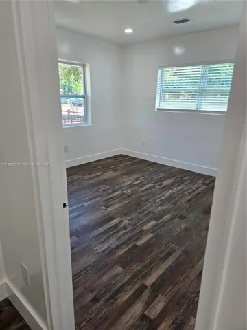 a view of a room with wooden floor