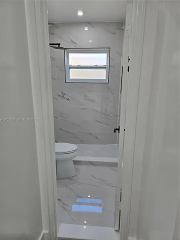 a white toilet sitting next to a bathroom sink
