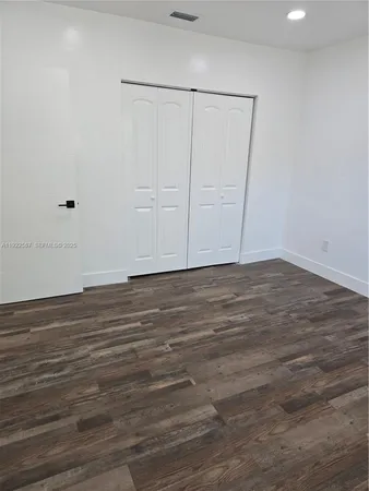 a large white kitchen with stainless steel appliances
