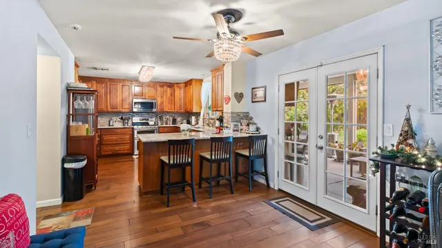 a room with stainless steel appliances a table chairs and a chandelier