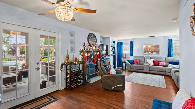 a living room with furniture and a wooden floor