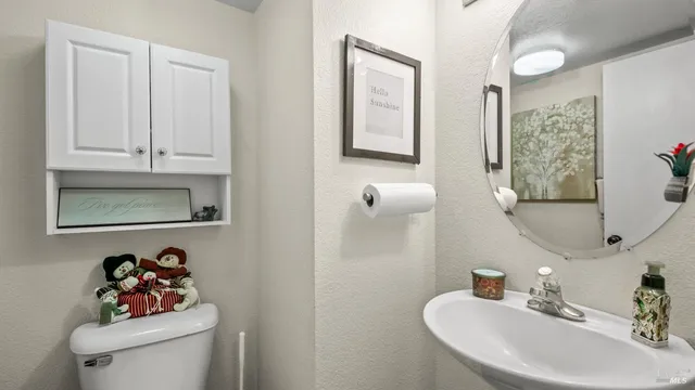 a bathroom with a sink mirror and toilet