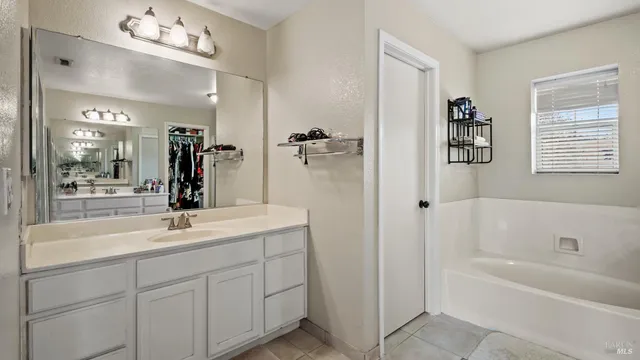 a bathroom with a sink a mirror and a bathtub