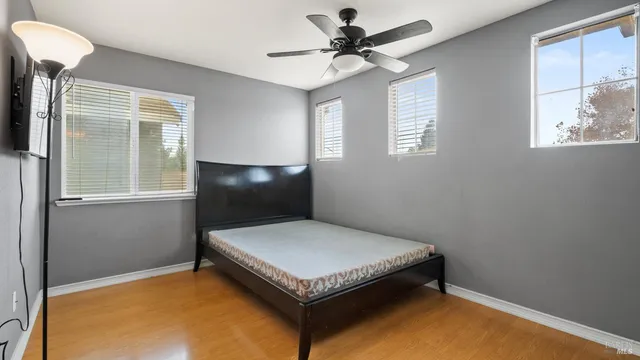 a bedroom with a bed and a window