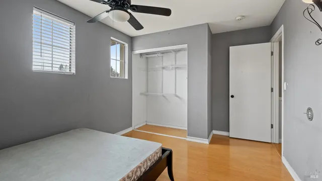 a bedroom with a bed and a chandelier fan