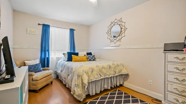 a bedroom with a bed window and a table in it